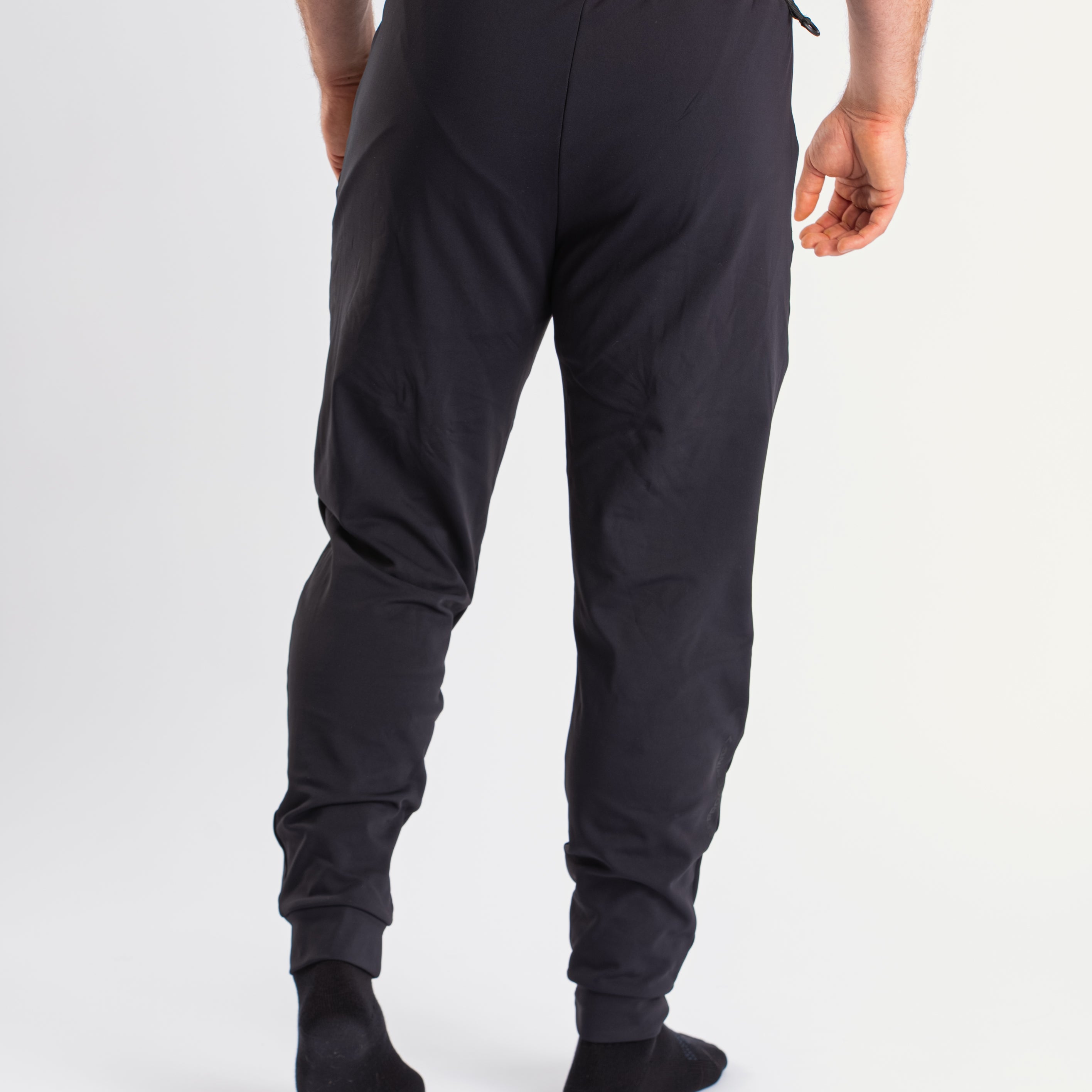 Back view of a7-us.mombra 360Go 1Z Joggers in Stealth, highlighting the elastic waistband and ankle cuffs.