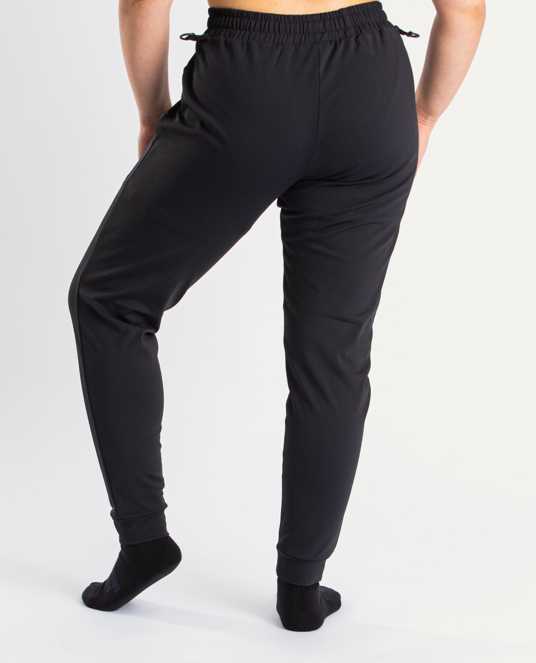 Back view of a7-us.mombra 360Go 1Z Joggers in Stealth, highlighting the elastic waistband and ankle cuffs