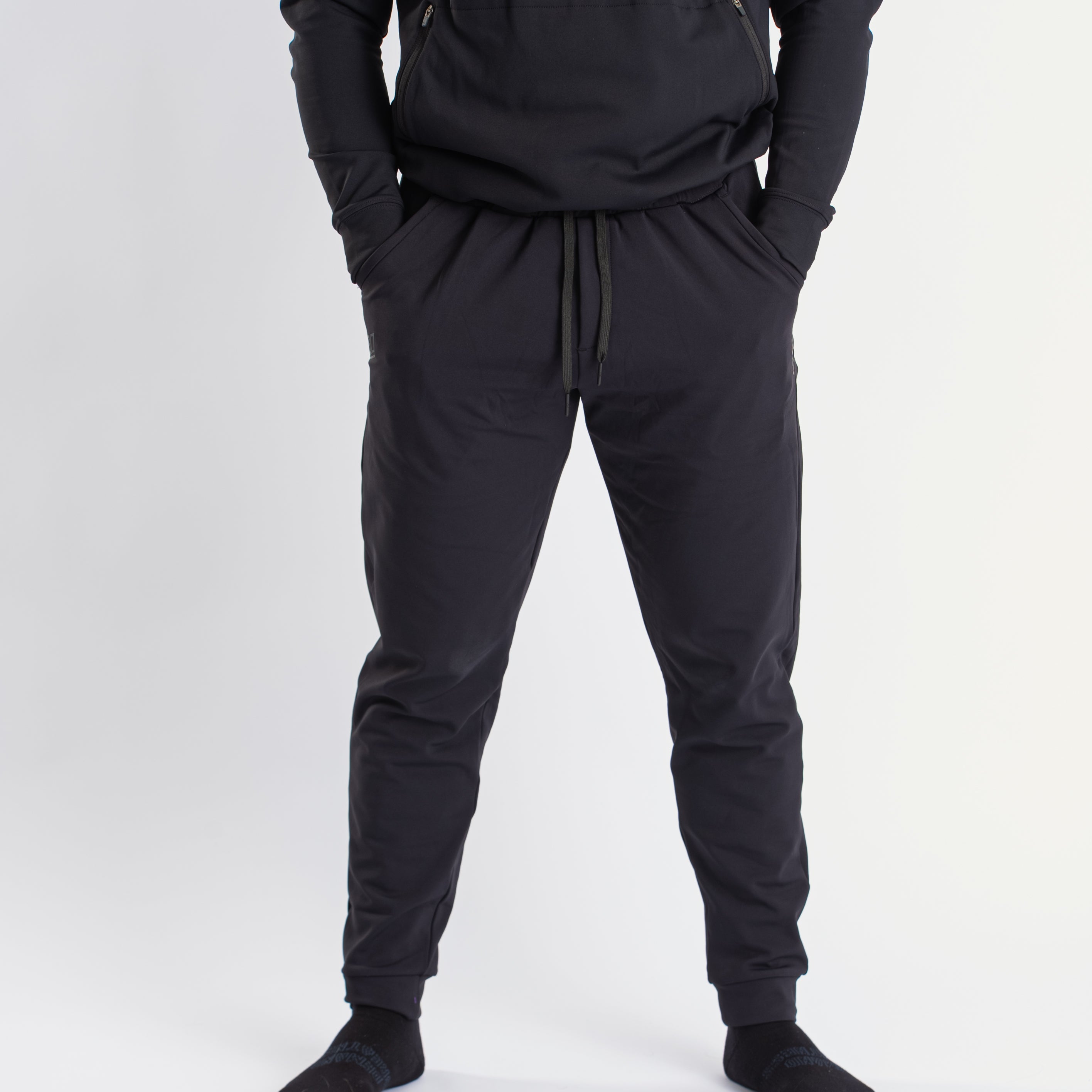 Front view of a7-us.mombra 360Go 1Z Joggers in Stealth, showcasing the sleek design and tapered leg fit.
