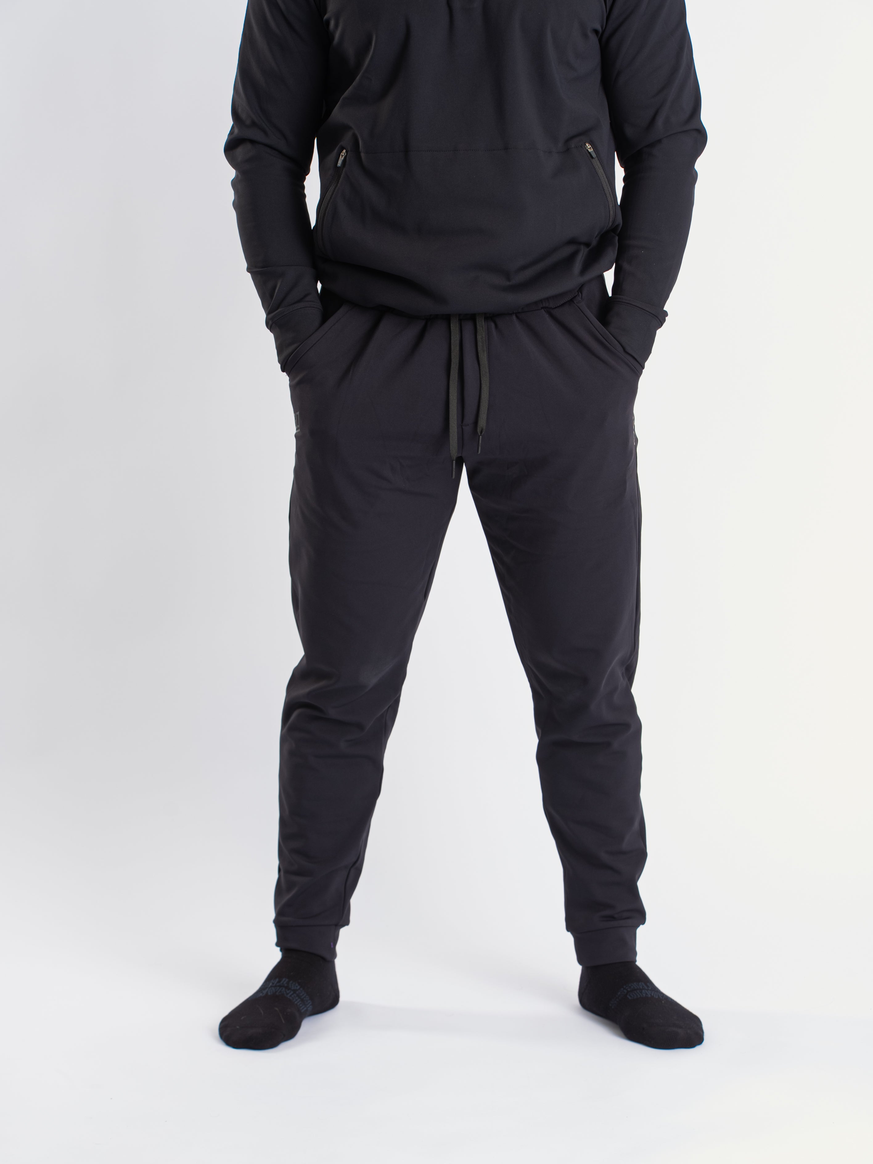 Front view of a7-us.mombra 360Go 1Z Joggers in Stealth, showcasing the sleek design and tapered leg fit.