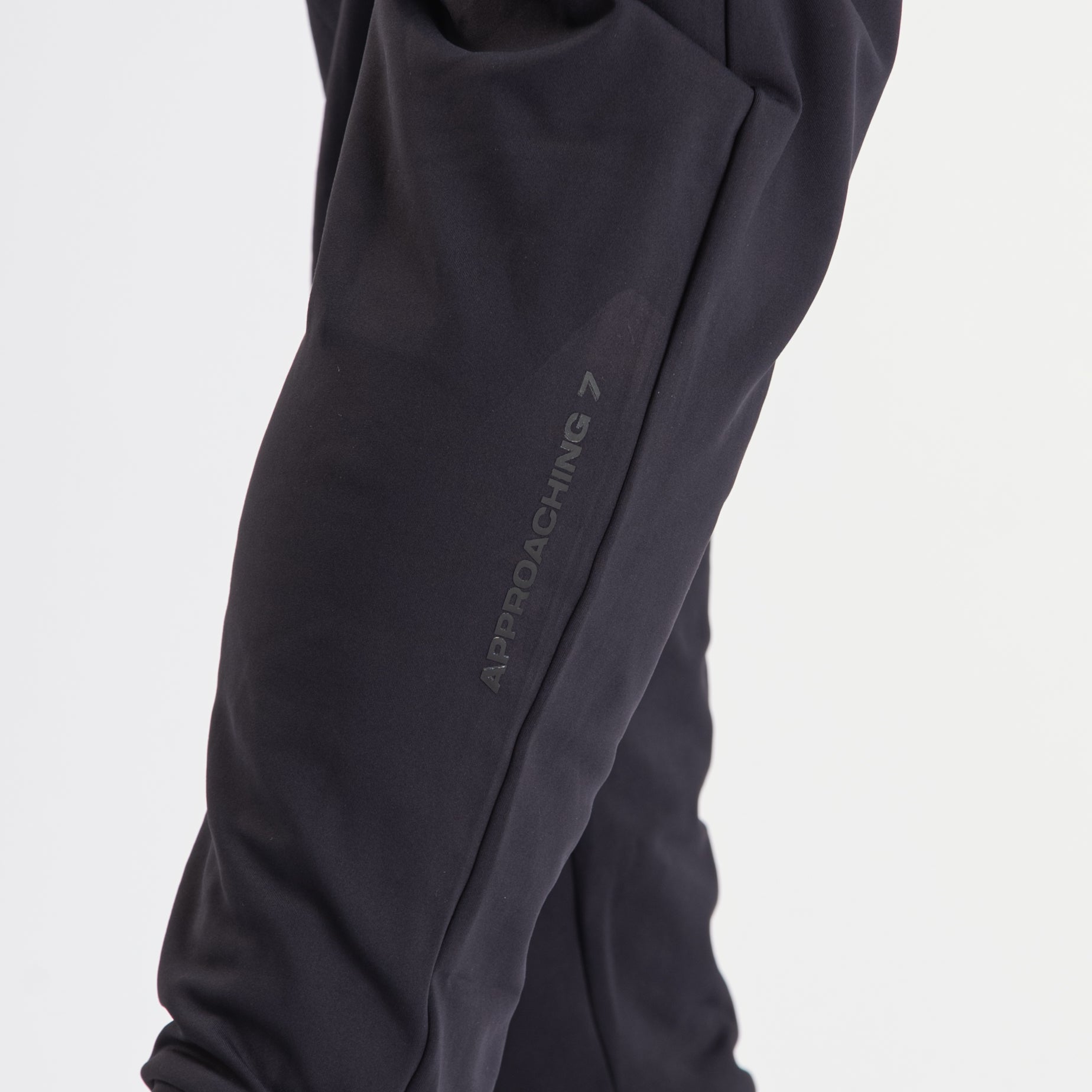 Close-up of the printed silicone A7 logo on the left leg of the Cobra 360Go 1Z Joggers in Stealth.