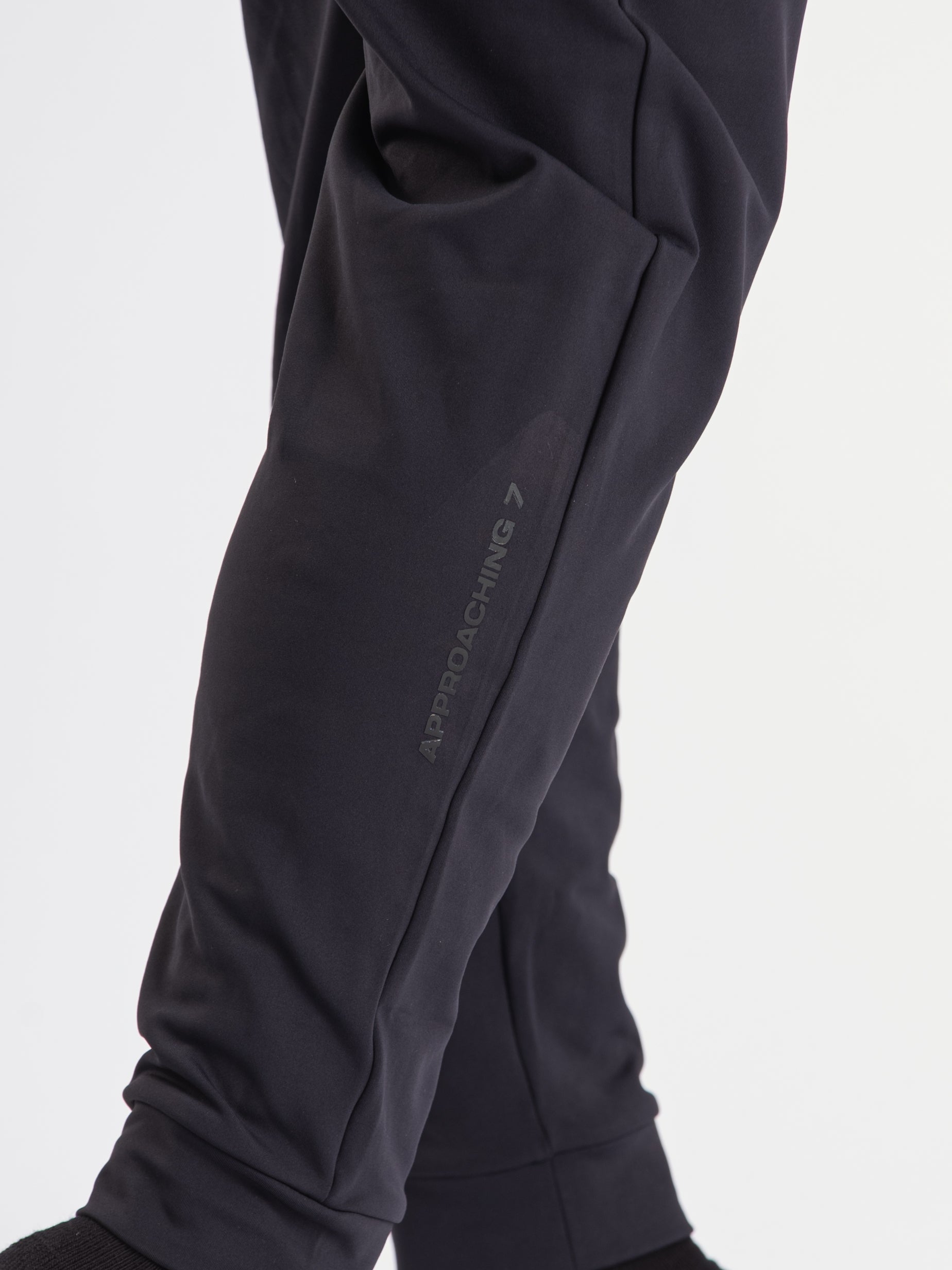 Close-up of the printed silicone A7 logo on the left leg of the Cobra 360Go 1Z Joggers in Stealth.