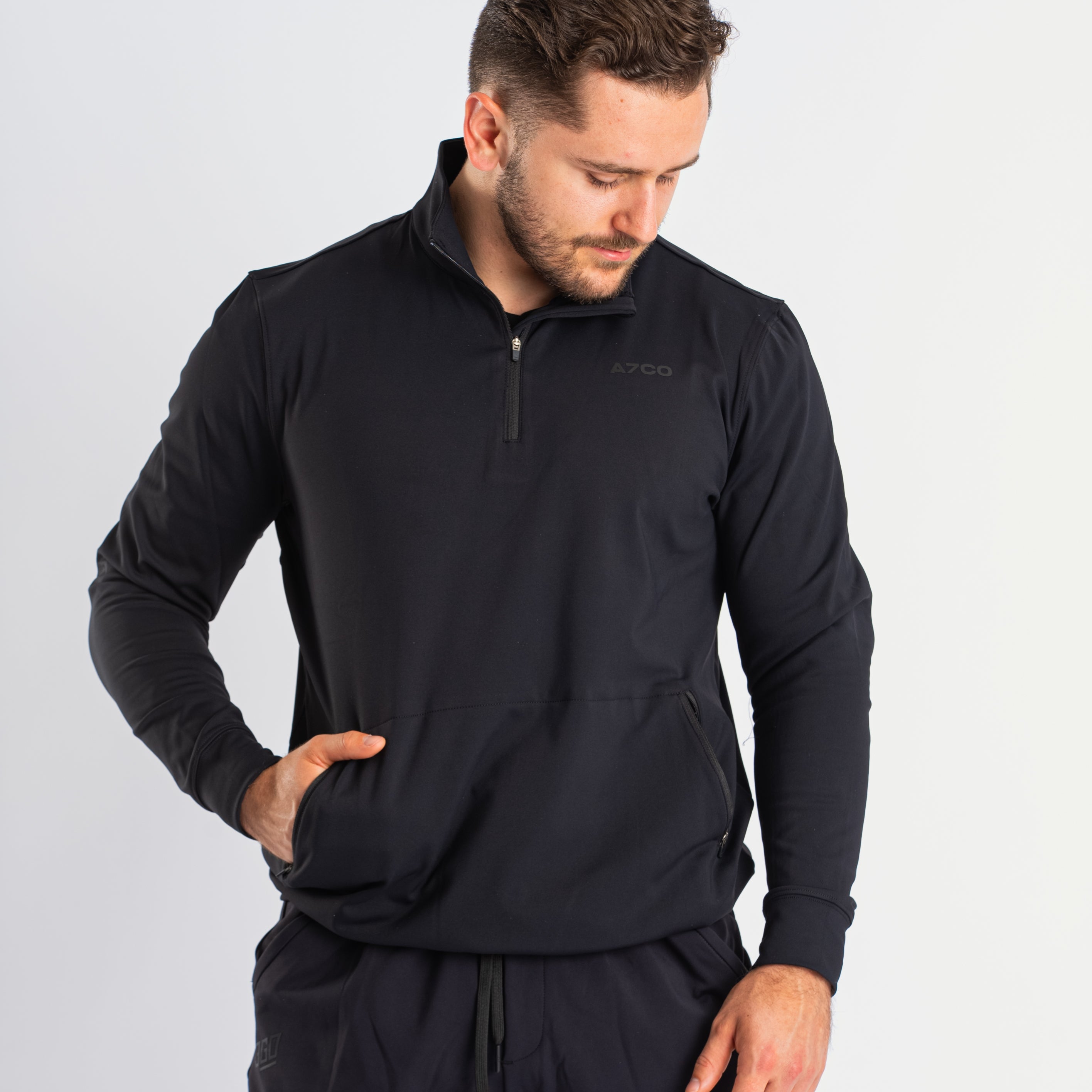 Front view of a7-us.mombra Quarter Zip Jacket in Stealth, showcasing the sleek design and quarter zip feature.