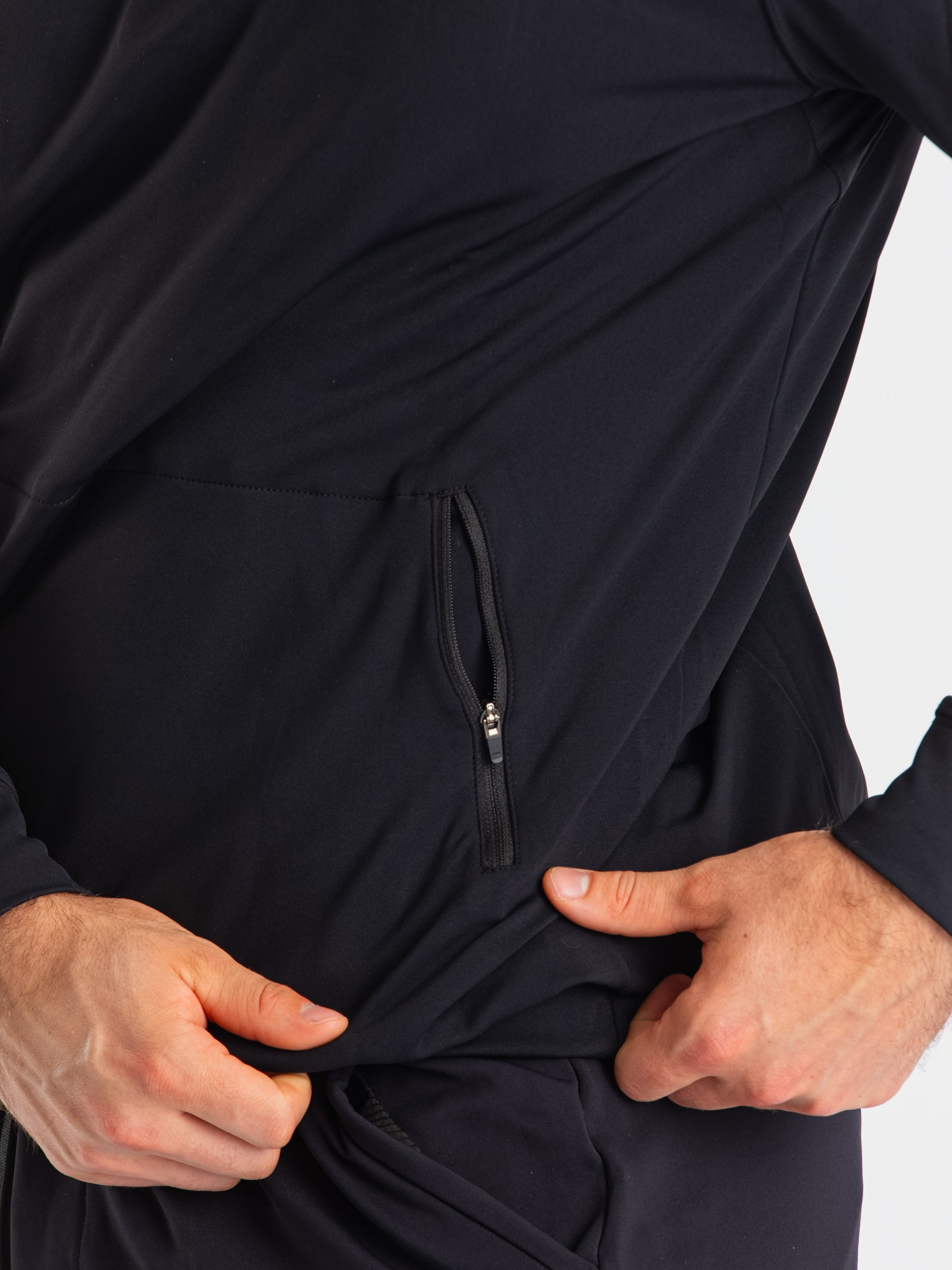 Close-up of the zippered pocket on the a7-us.mombra Quarter Zip Jacket – Stealth, designed for secure storage with a clean, minimalist finish.