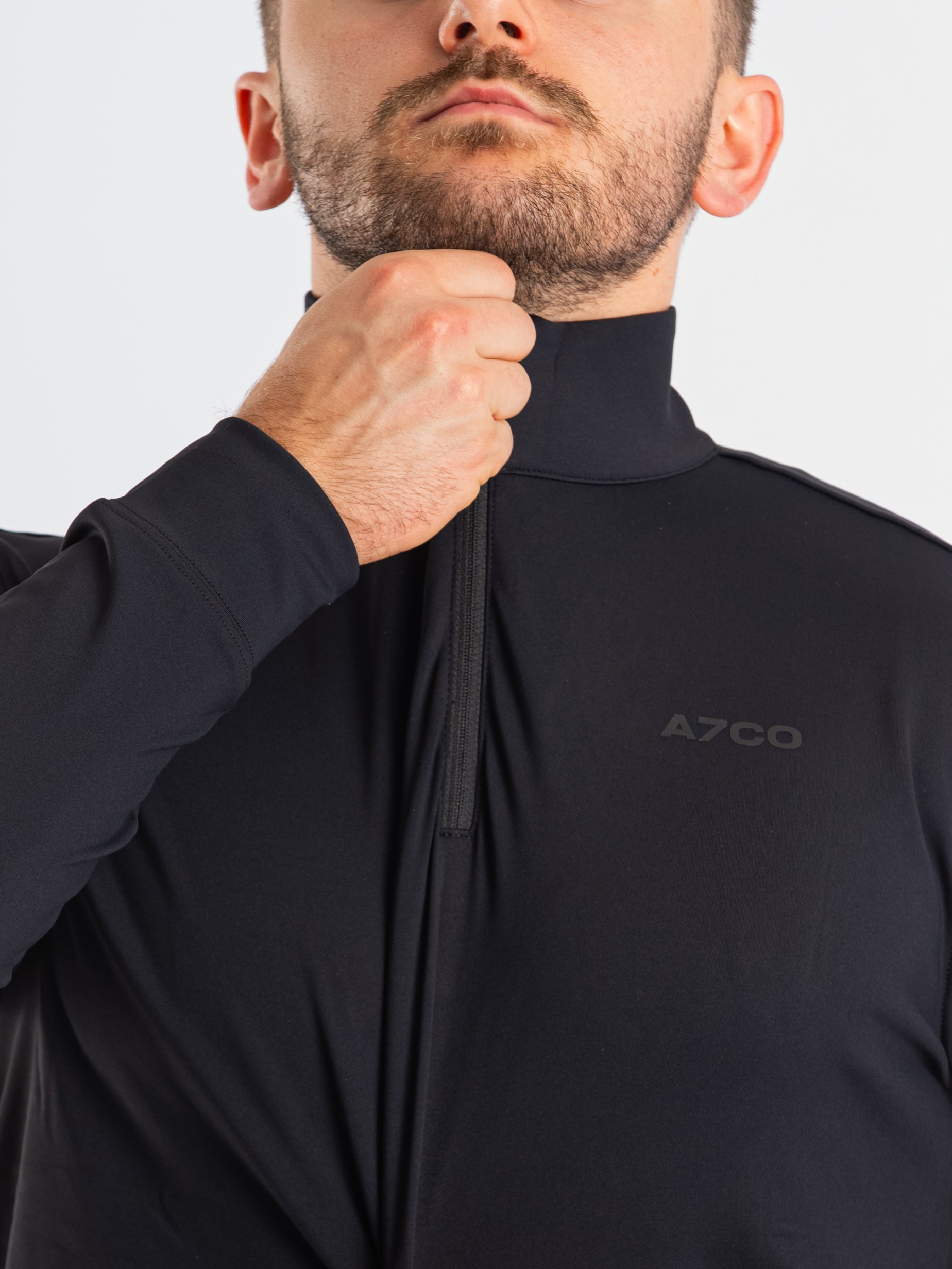 Close-up of the YKK quarter zipper on the a7-us.mombra Quarter Zip Jacket – Stealth, highlighting durable construction and clean collar finish.