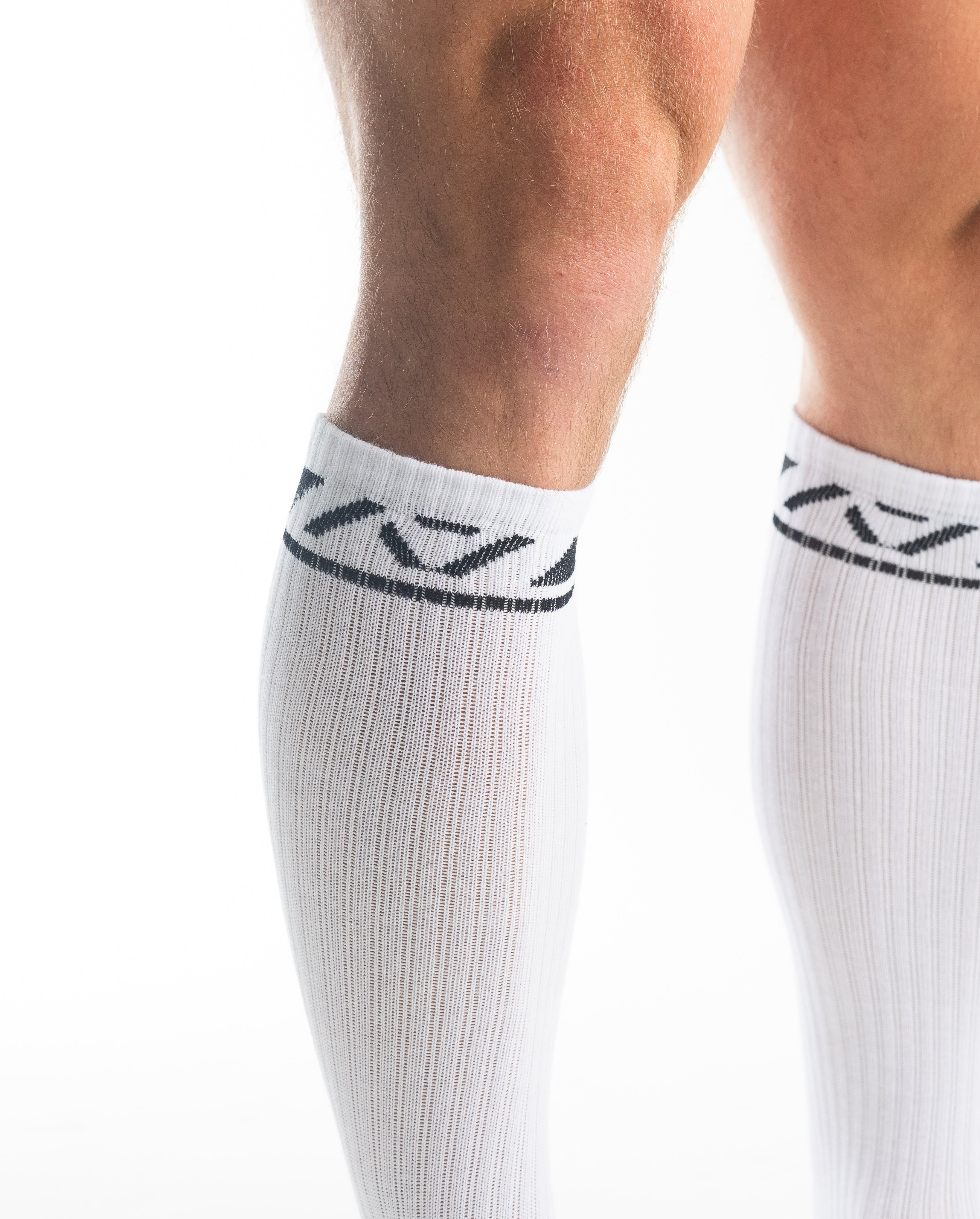 Close-up of the knit fabric on A7 Deadlift Socks in Domino White, showing texture and stitching details.