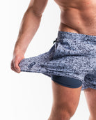 Demonstration of the 360-degree stretch fabric on A7 360Go 1Z KWD Shorts in Foggy Navy, offering full range of motion for training and lifting