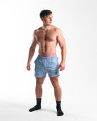 Full body shot of athlete wearing A7 360Go 1Z KWD Shorts in Slate Blue, showcasing overall fit and athletic performance style.