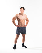 Full body view of athlete wearing A7 360Go KWD Shorts in Stelacrosha Black, showcasing premium fit and bold, all-black aesthetic.