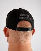 Rear view of 5 Panel Snapback Hat in Shadow Stone with adjustable snapback closure and breathable fabric. With Demand Greatness.