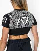 Person wearing a black sports outfit with bar grip and branding on a white background