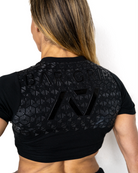Person wearing a black athletic outfit with A7 bar grip on a white background