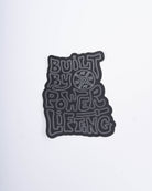 Front view of A7 Built By Sticker showcasing bold "Built By Powerlifting" text on matte polypropylene.