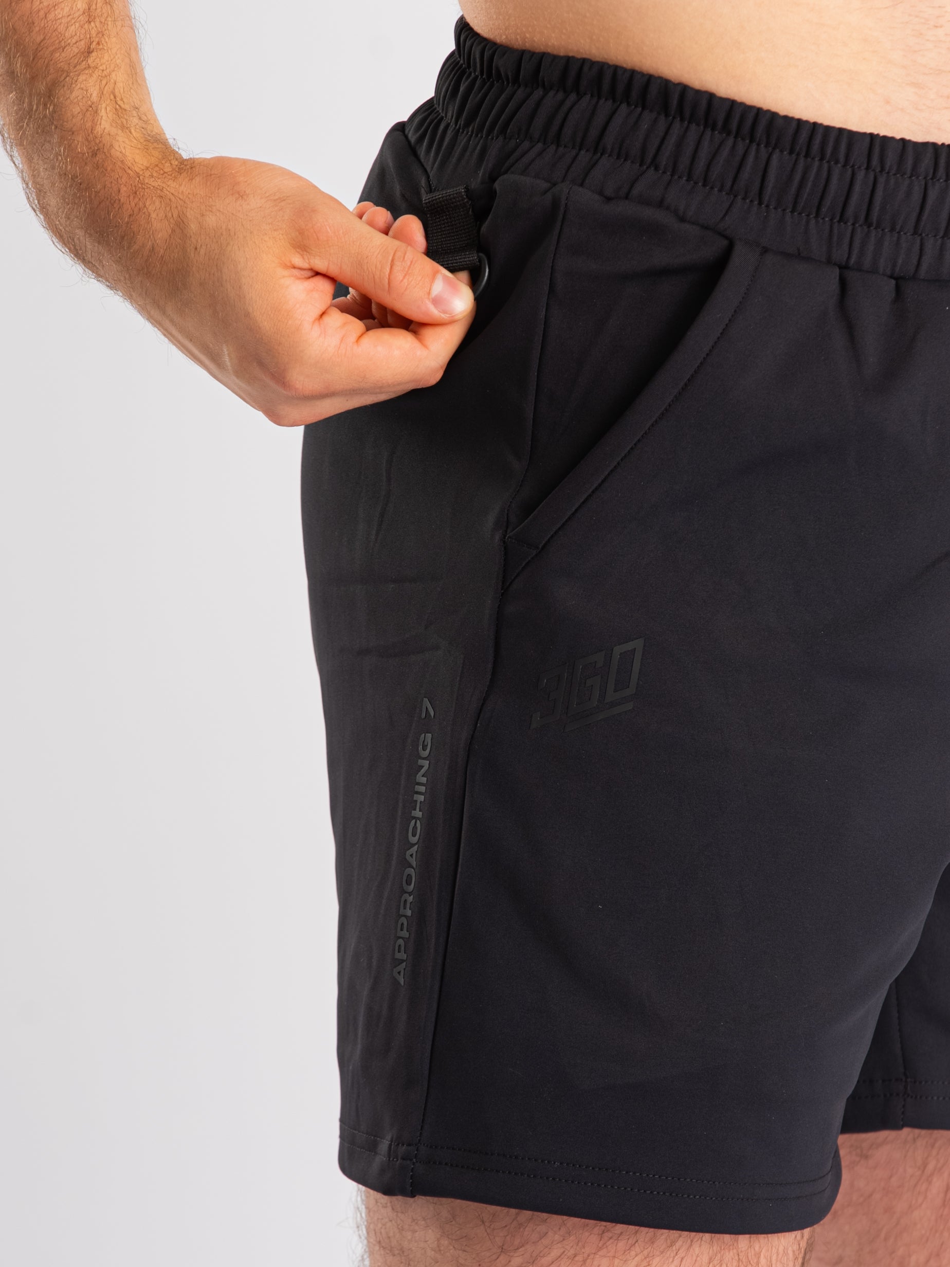 Close-up of dual key clips on the a7-us.mombra 360Go 1Z Shorts – Stealth, providing secure attachment points for keys or accessories on both sides.