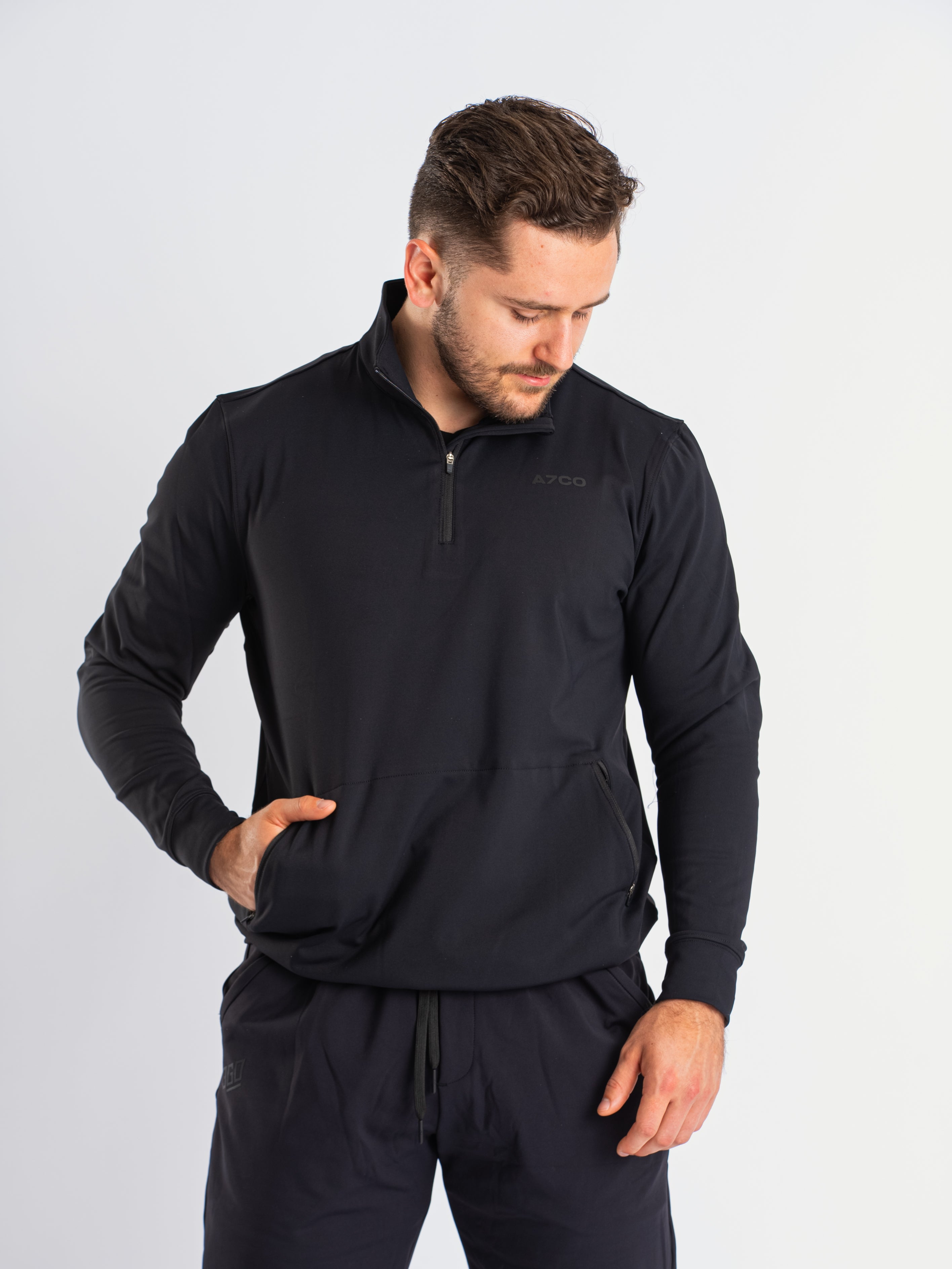 Front view of a7-us.mombra Quarter Zip Jacket in Stealth, showcasing the sleek design and quarter zip feature.