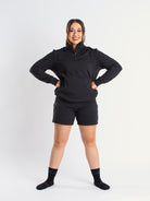 Athlete wearing the a7-us.mombra Quarter Zip Jacket in Stealth, demonstrating fit and style in a gym setting.