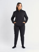 Athlete wearing the a7-us.mombra Quarter Zip Jacket in Stealth, demonstrating fit and style in a gym setting.