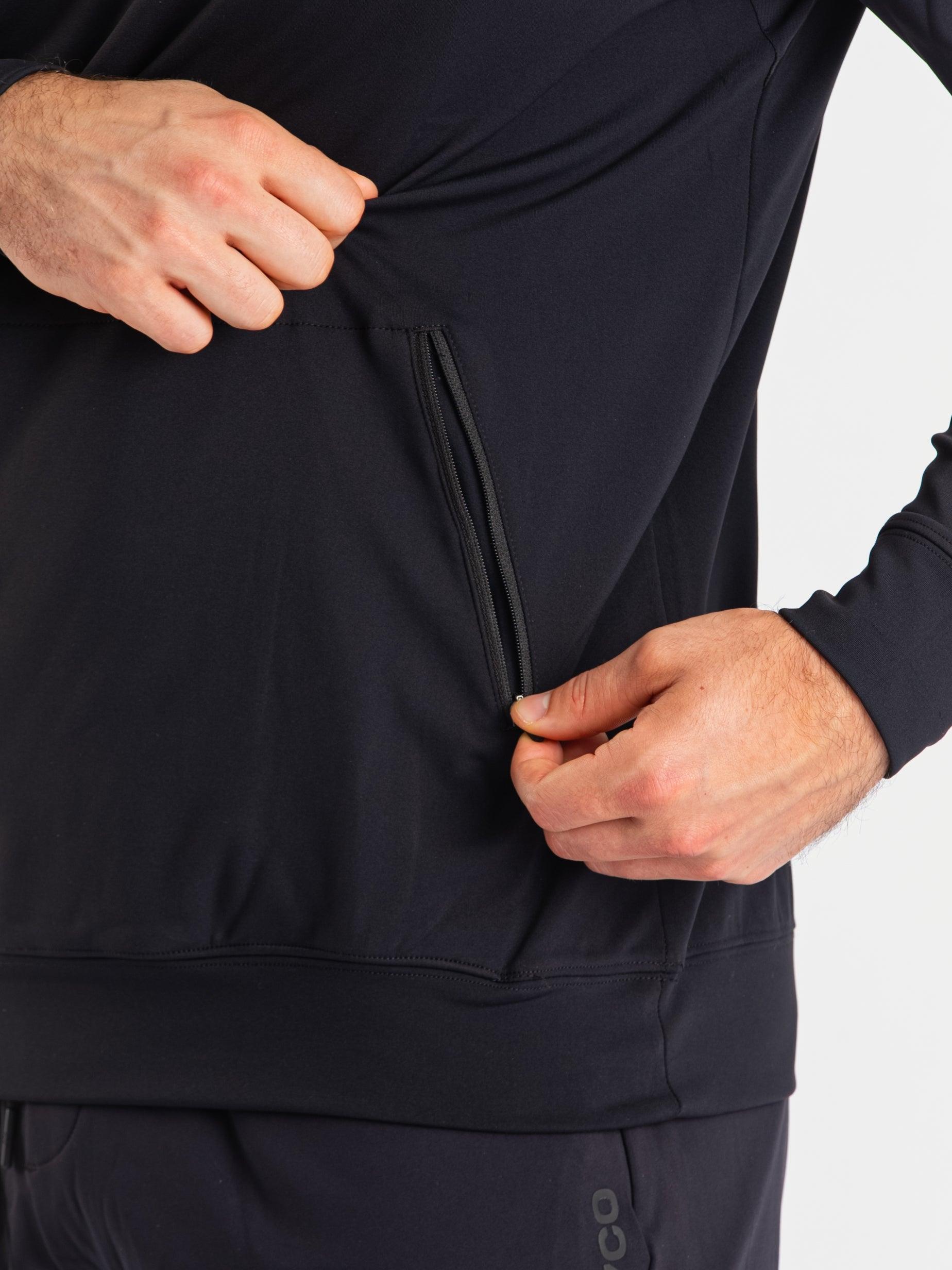 Close-up of the zippered pocket on the a7-us.mombra Quarter Zip Jacket – Stealth, designed for secure storage with a clean, minimalist finish.