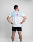 Person wearing a white t-shirt with a7 Bar Grip on the back against a gray background