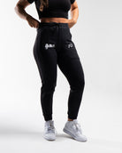 Front view of the USAPL Classic Defy Joggers showing zippered pockets, mid-rise waist, and logos.
