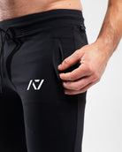 Close-up of front zippered pocket and moisture-wicking stretch fabric.