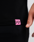 Close-up of woven A7 hem tag along the bottom hem of the Flamingo shirt.