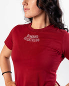 Close up of DEMAND GREATNESS text on the top of center chest of meet shirt to show underneath singlet