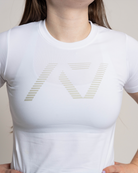 White t-shirt with a logo worn by a person against a neutral background