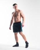 Full body image of athlete wearing A7 360Go KWD Shorts in Azul, showcasing vibrant blue style and performance fit.