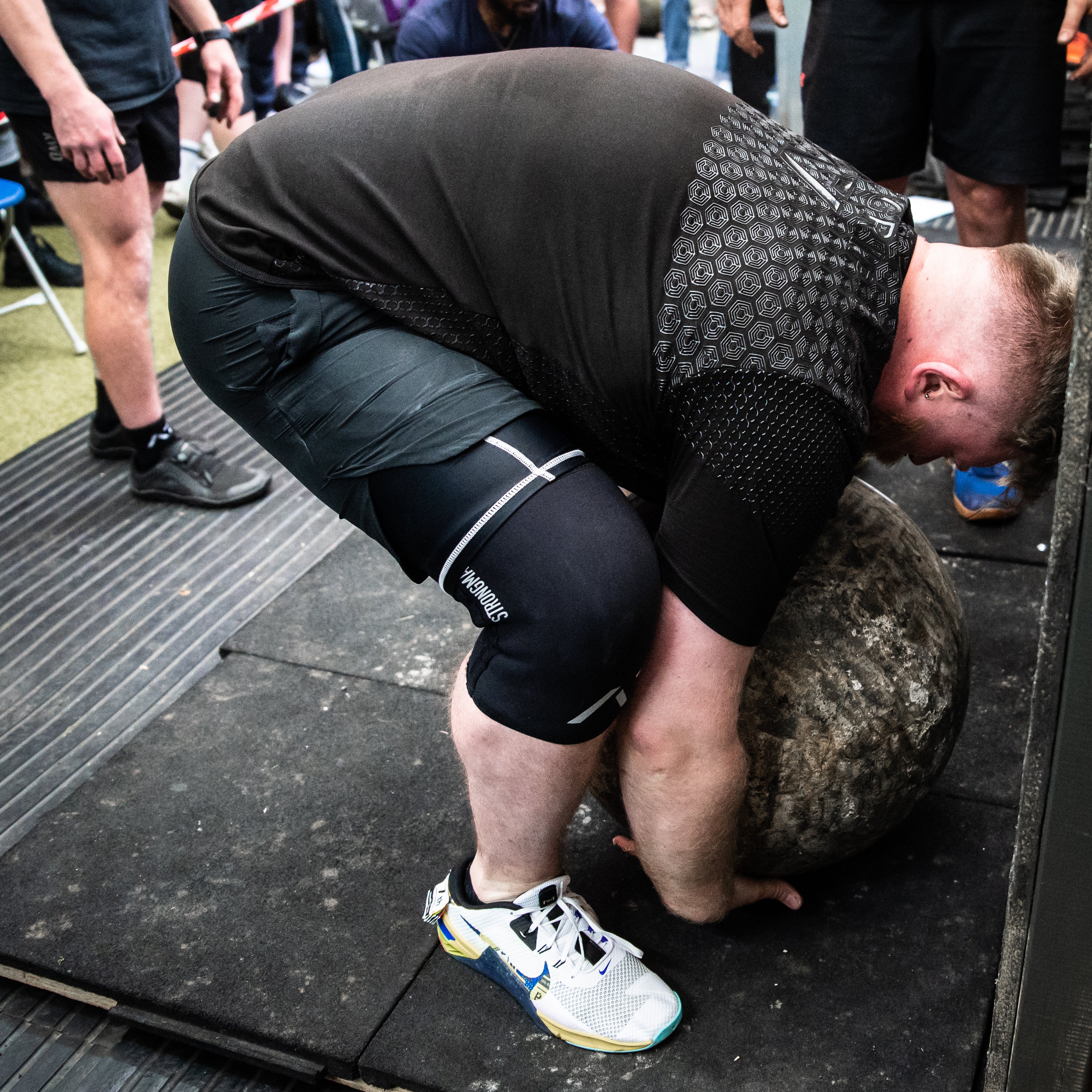 Athlete competing in strongman with  A7 Strongman Knee Sleeves – 9mm – Black/Reflective