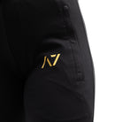Close-up of gold silicone A7 logo printed on thigh for subtle branding.